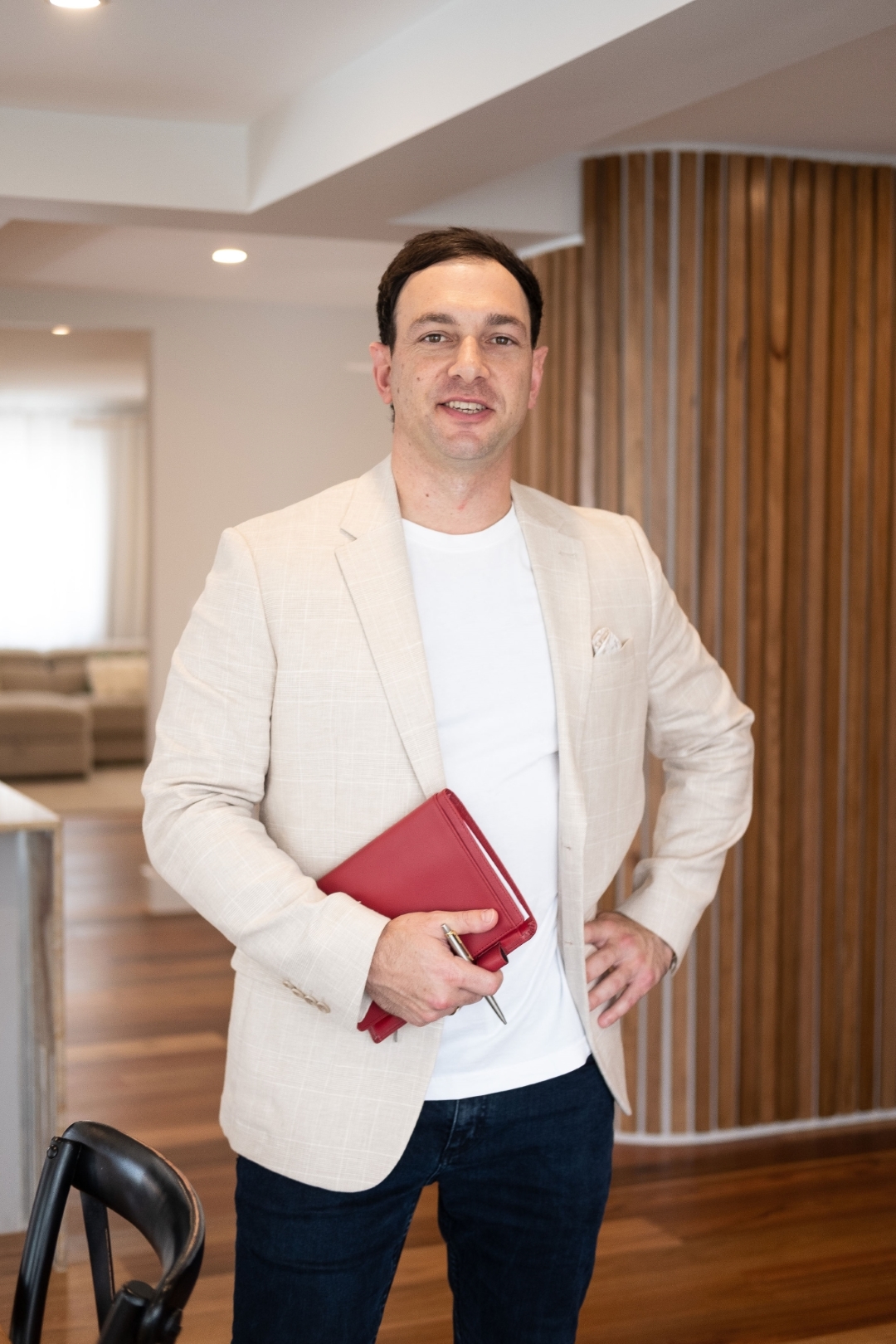 Photo of Andrew Pizzino holding a red planner | image for the Home page.
